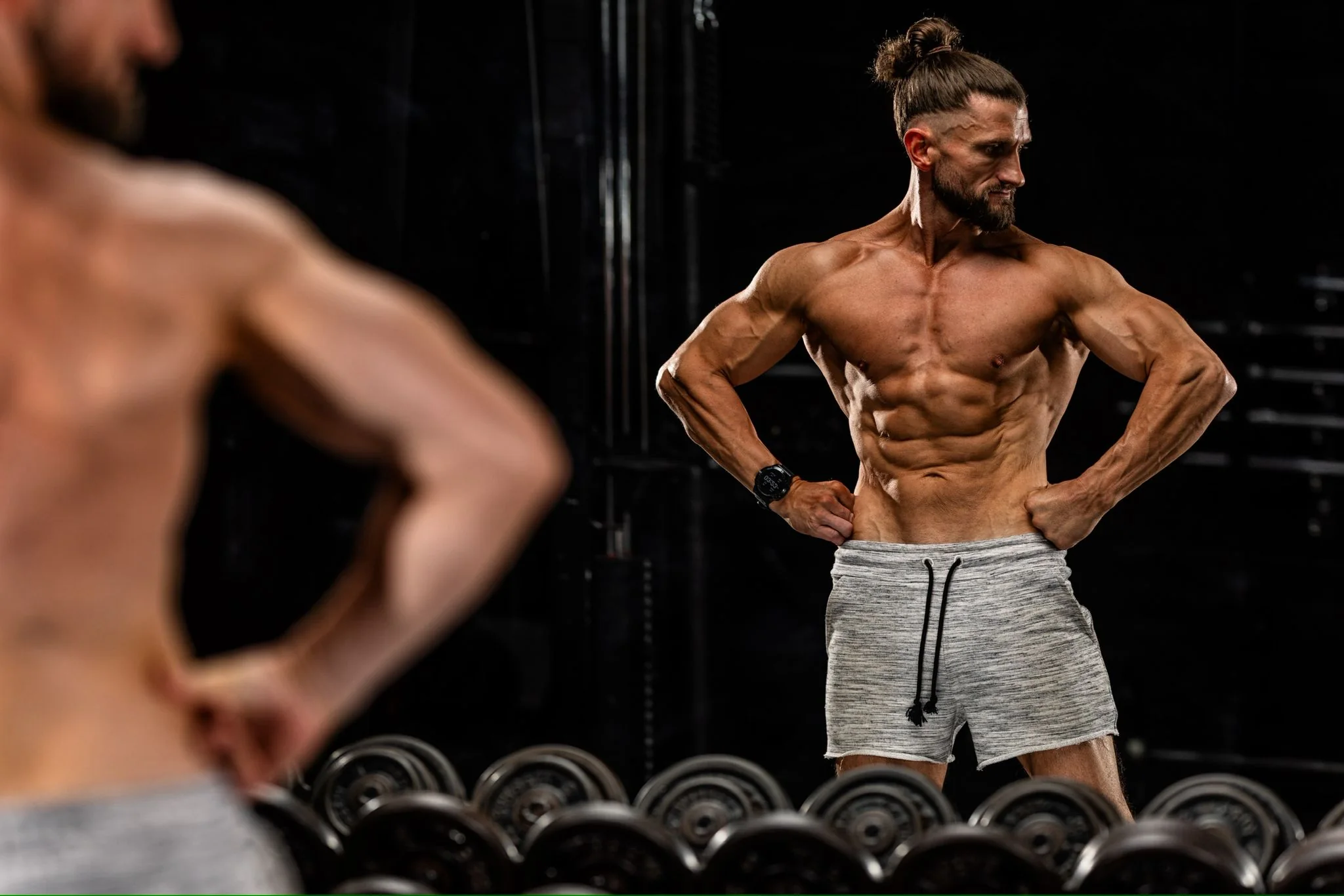 Nick training with weights under warm studio light